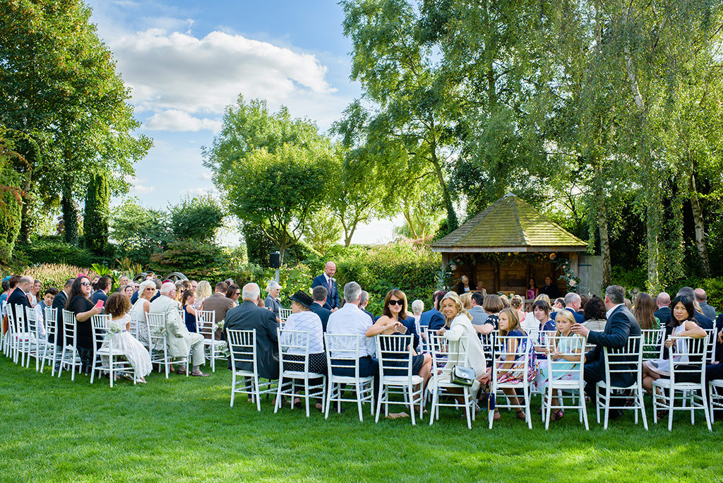 guests wait for bride at Autumn wedding at South Farm, Hertfordshire