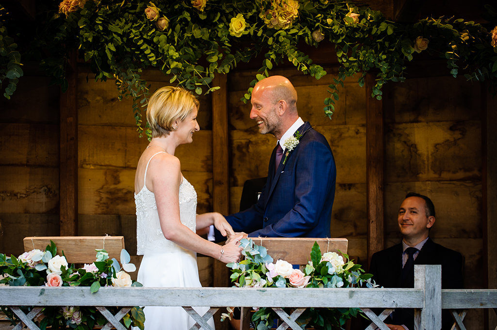 bride and groom say vows at Autumn wedding at South Farm, Hertfordshire