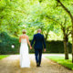 bride and groom walk at Autumn wedding at South Farm in Hertfordshire