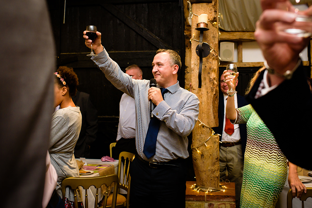 Guest toasts at Autumn wedding at South Farm in Hertfordshire