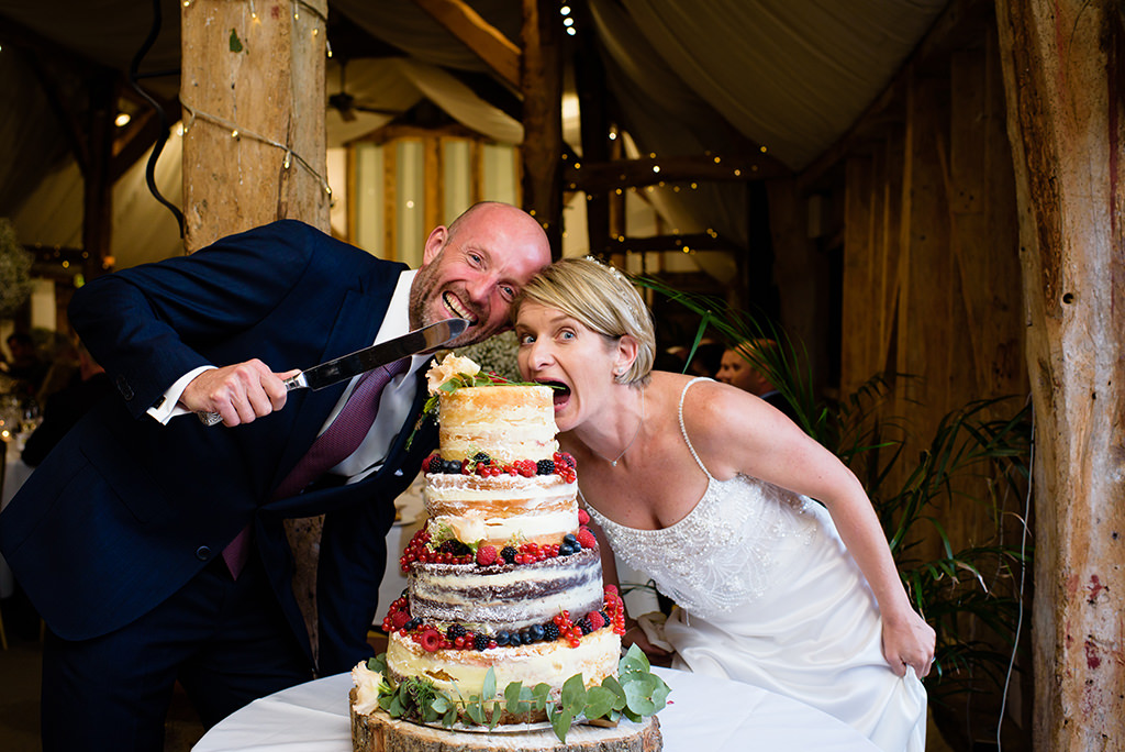 cutting the cake at Autumn wedding at South Farm in Hertfordshire