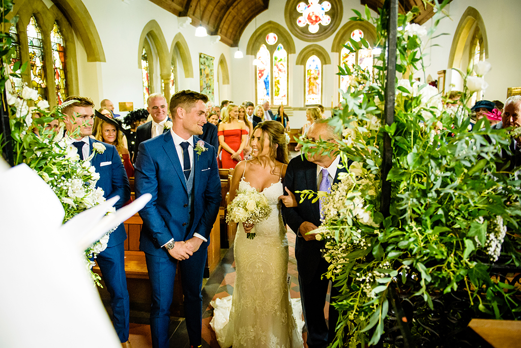 bride walks down the aisle Ayot St Lawrence church in Hertfordshire