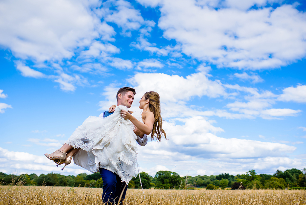 bride and groom pose in hertfordshire countryside