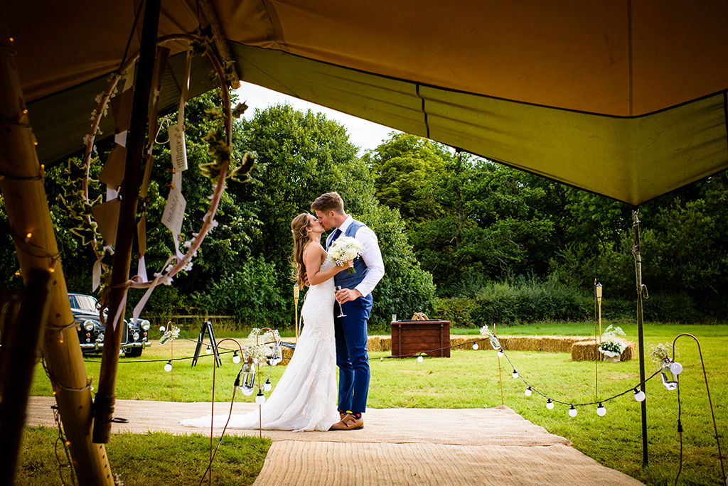 bride and groom kiss at their hertfordshire tipi wedding