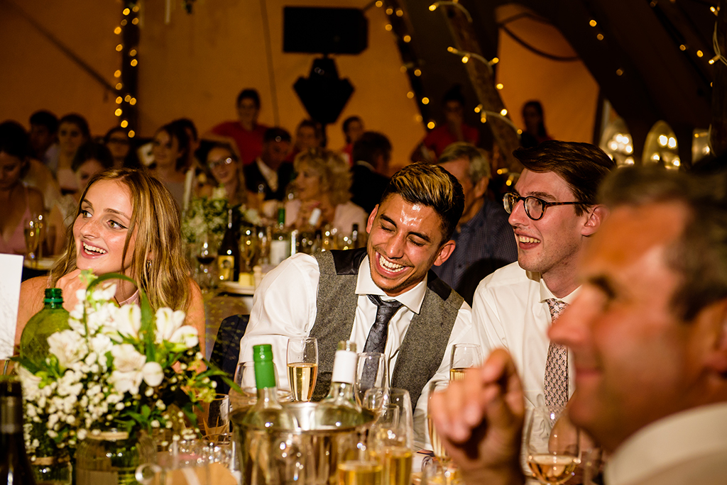 guests laugh at hertfordshire tipi wedding speeches