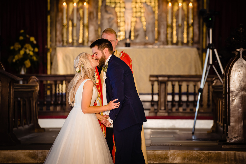 bride and groom kiss at st ethaldredas church old hatfield Hertfordshire