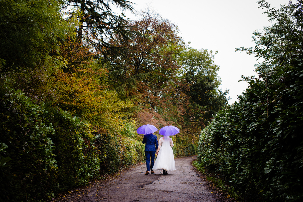bride and groom on rainy wedding day in hertfordshire