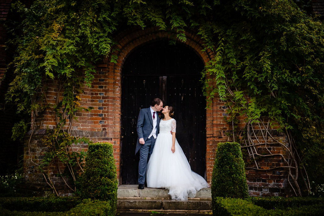 bride and groom on their rainy wedding at hatfield house wedding day in hertfordshire