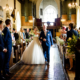 bride walks down the aisle at St Elthandreds church in hatfield, Hertfordshire