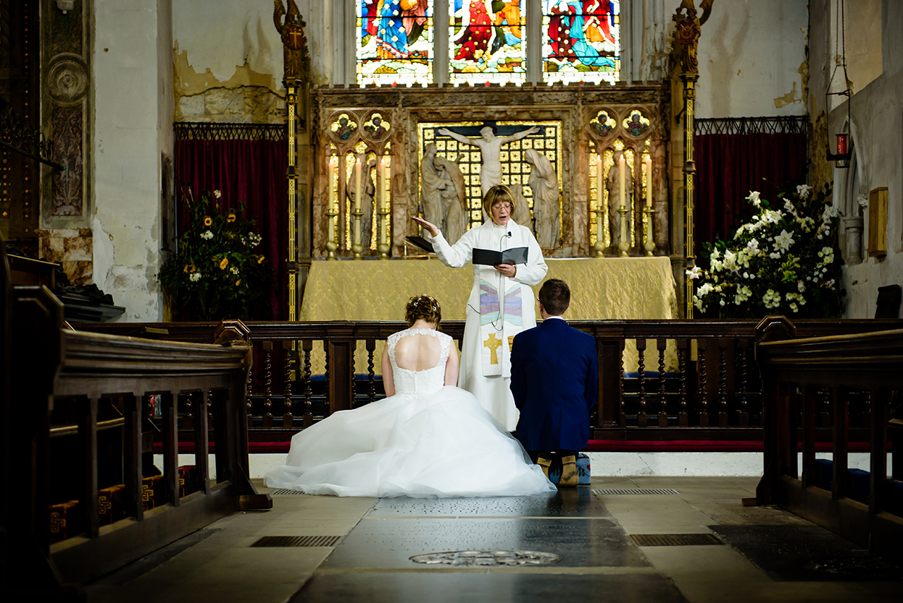 bride and groom at their wedding ceremony at St Elthandreds church in hatfield, Hertfordshire