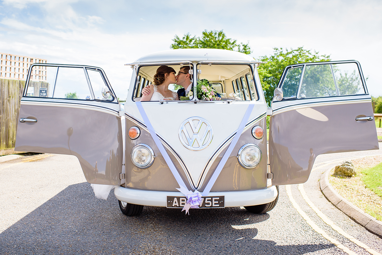 bride and groom kiss in wedding car at chesfield downs wedding venue in hertfordshire