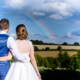 bride and groom and rainbow at chesfield downs wedding venue in hertfordshire
