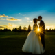 bride and groom kiss during sunset at chesfield downs wedding venue in hertfordshire