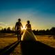 bride and groom walk in sunset at chesfield downs wedding venue in hertfordshire