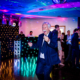 wedding guests are dancing at chesfield downs wedding venue in hertfordshire