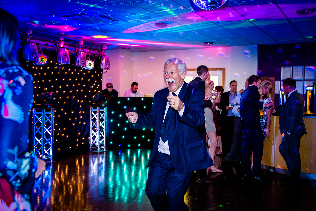 wedding guests are dancing at chesfield downs wedding venue in hertfordshire