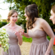 bridesmaid catches bouquet at Hastoe village Hall in Hertfordshire