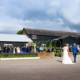 Bride and Groom walk to guests at Milling Barn wedding venue in Hertfordshire