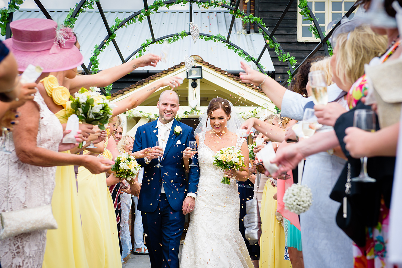 Bride and Groom confetti throw at Milling Barn wedding venue in Hertfordshire