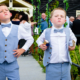 Page boys eat ice cream at Milling Barn wedding venue in Hertfordshire