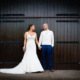 Bride and Groom by the barn doors at Milling Barn wedding venue in Hertfordshire