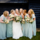 Bride and her bridesmaids pose at Milling Barn wedding venue in Hertfordshire