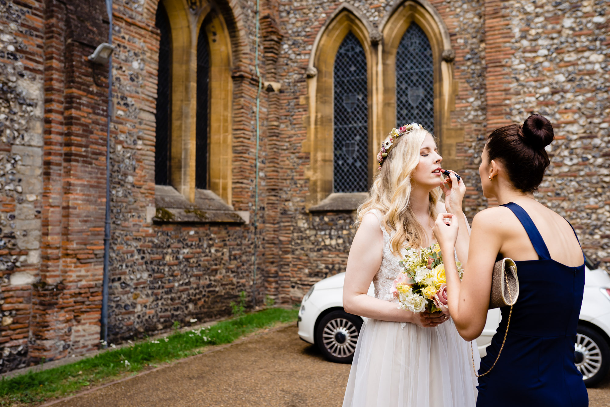 lipstick retouch outside St Albans Cathedral wedding, Hertfordshire  